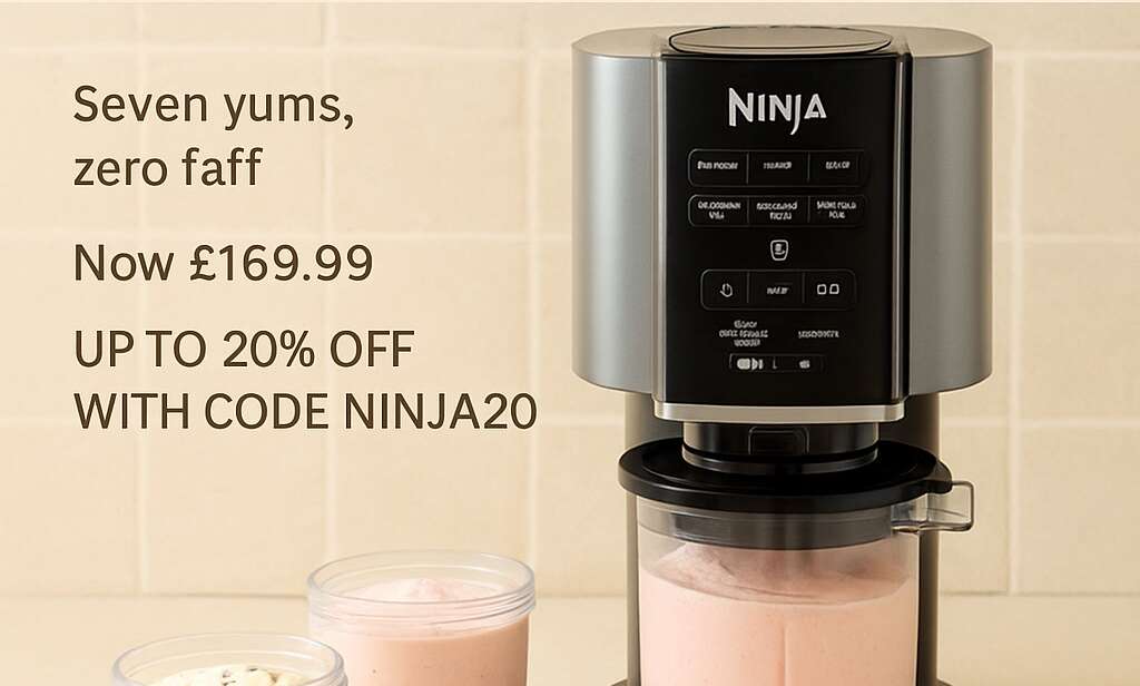 Ninja CREAMi machine on a kitchen counter with pints of ice cream and toppings