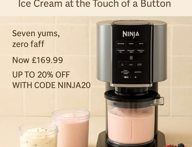Ninja CREAMi machine on a kitchen counter with pints of ice cream and toppings